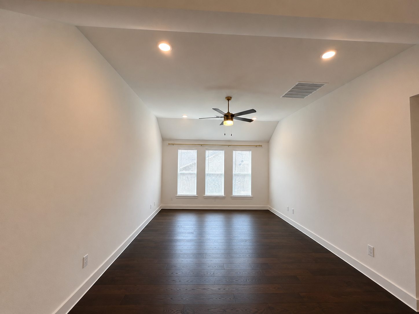 Freshly painted room with dark wood flooring